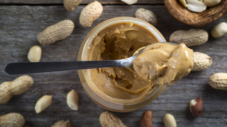 Spoonful of peanut butter on top of jar