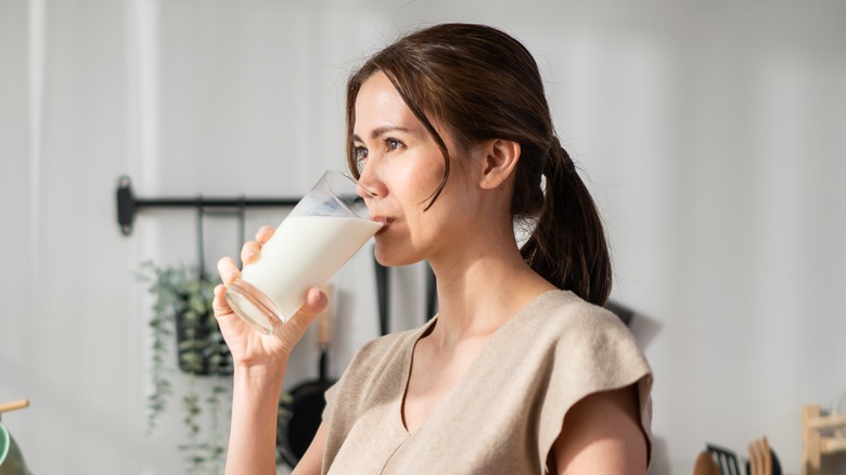 woman drinking a glass of milk