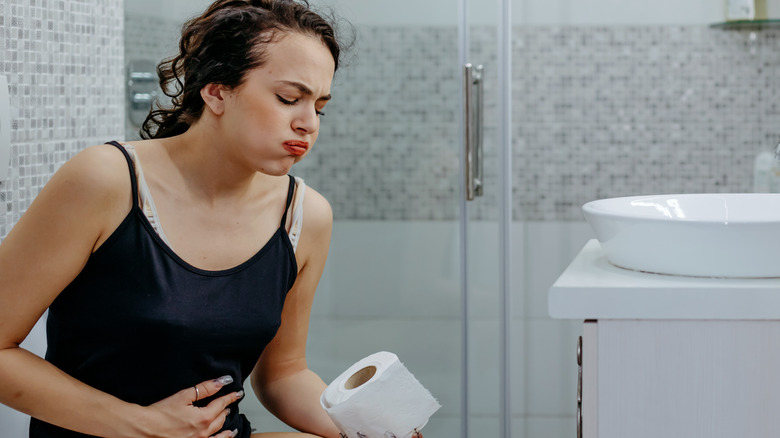 Woman having painful poop