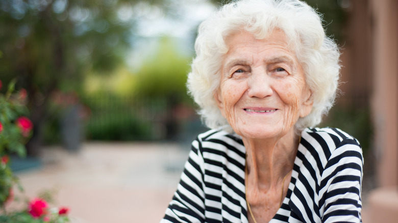 Older woman smiling outdoors