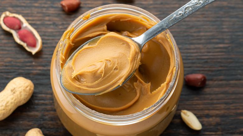 spoon scooping peanut butter from jar