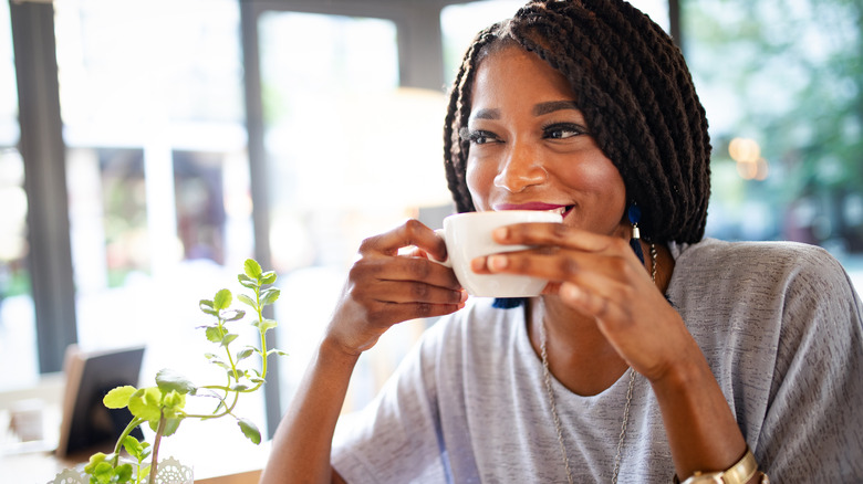 Smiling woman holding coffee cup