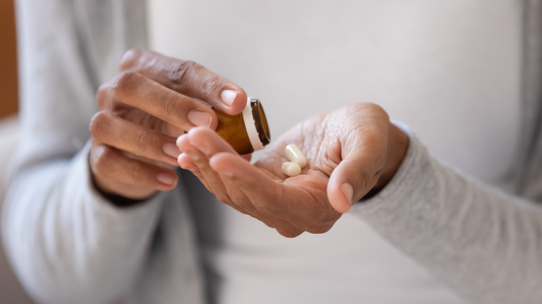 woman's hands holding medication