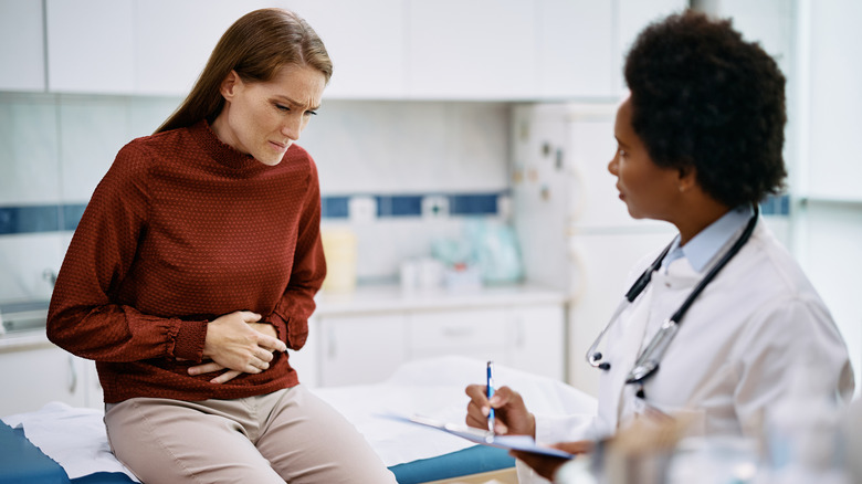 Patient with stomach pain visiting doctor