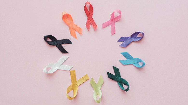 Cancer ribbons on pink background, cancer awareness, 