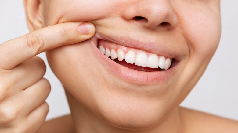 Cropped shot of a young woman showing healthy gums. 