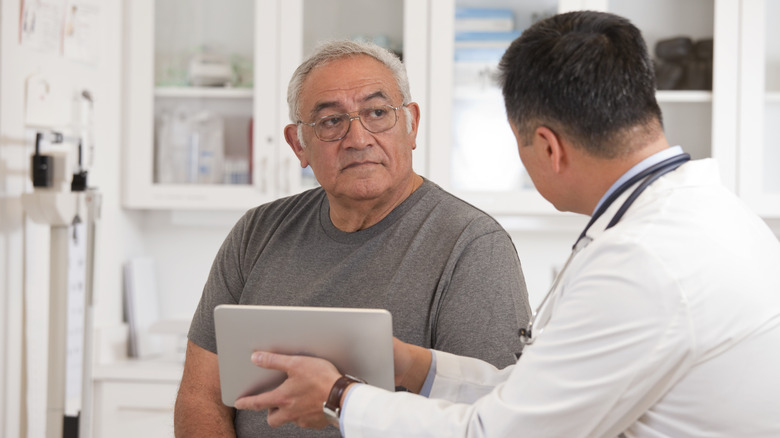 Man with abdominal pain visiting doctor