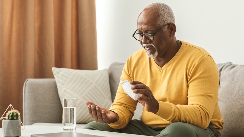 older man taking medication