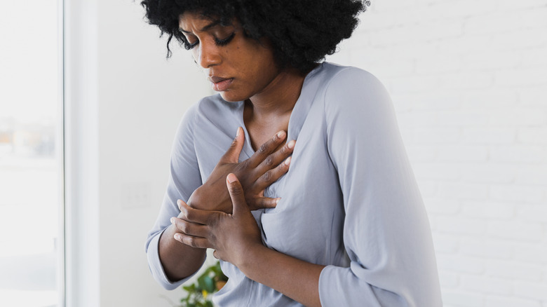 woman having esophageal pain after swallowing a button battery