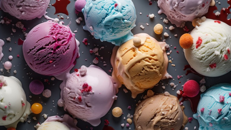 variety of scoops of ice cream flavors on a table