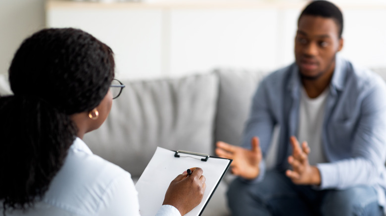 Young man consulting with therapist