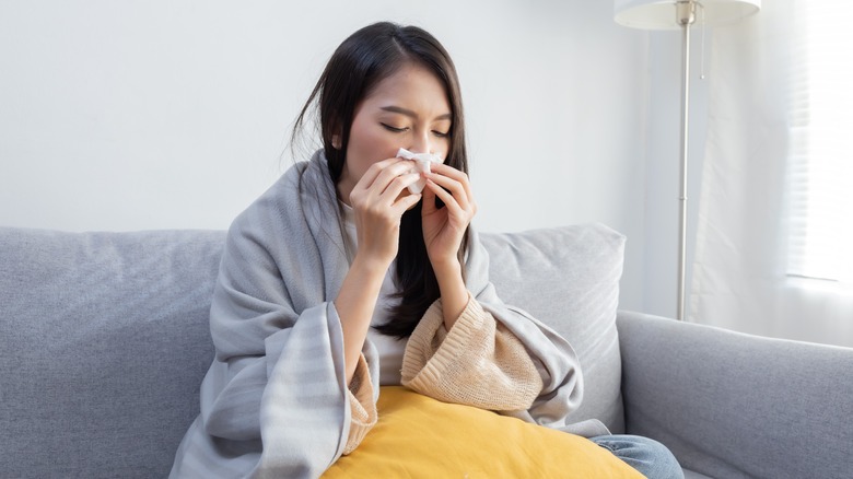 Woman with flu on couch