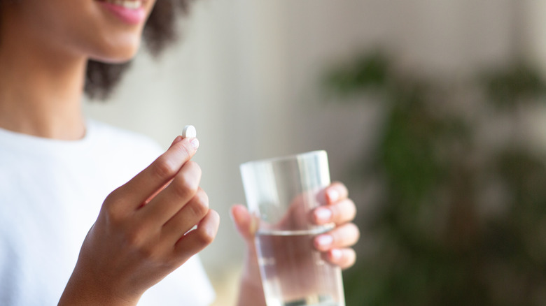 woman taking pill