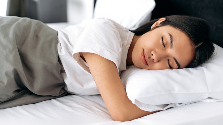 woman sleeping blissfully in bed