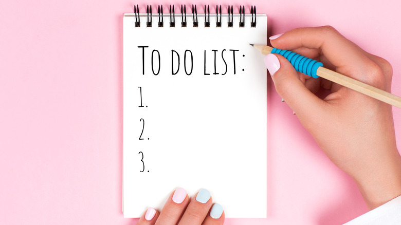 person writing to do list