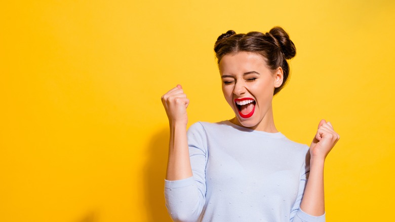 Cheerful woman, yellow background