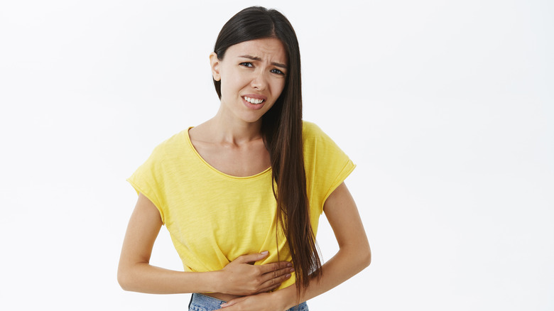 woman holding abdomen