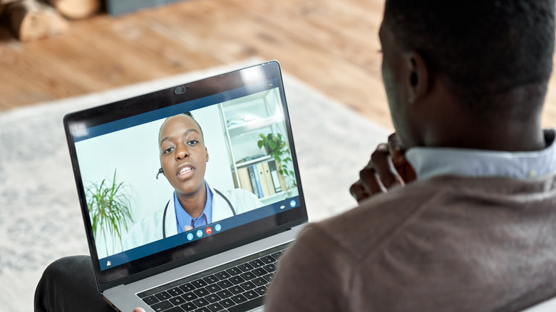 Male patient on video call with doctor
