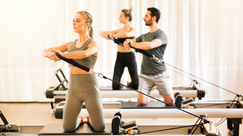 group workout class using Pilates reformers 