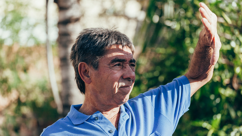 Man shielding face from sunlight