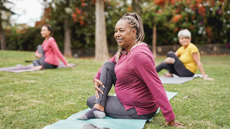 People practicing yoga outside