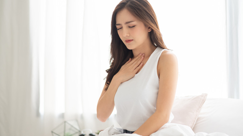 woman holding chest