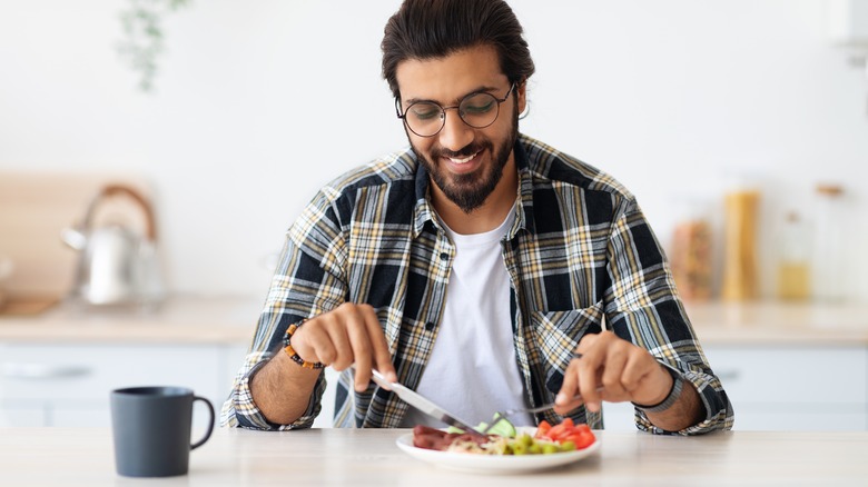 A man eats a healthy dinner