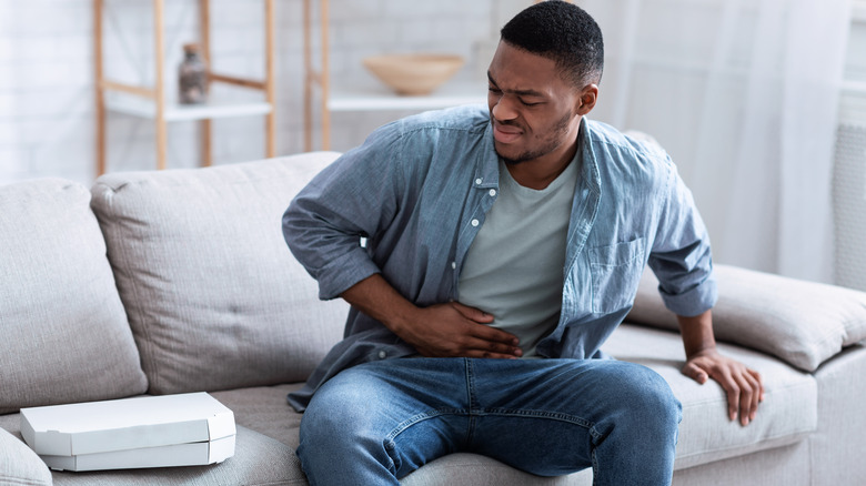 Man with food poisoning holding his stomach