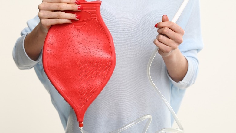 woman holding enema bag 