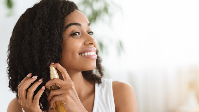 Woman applying hair product