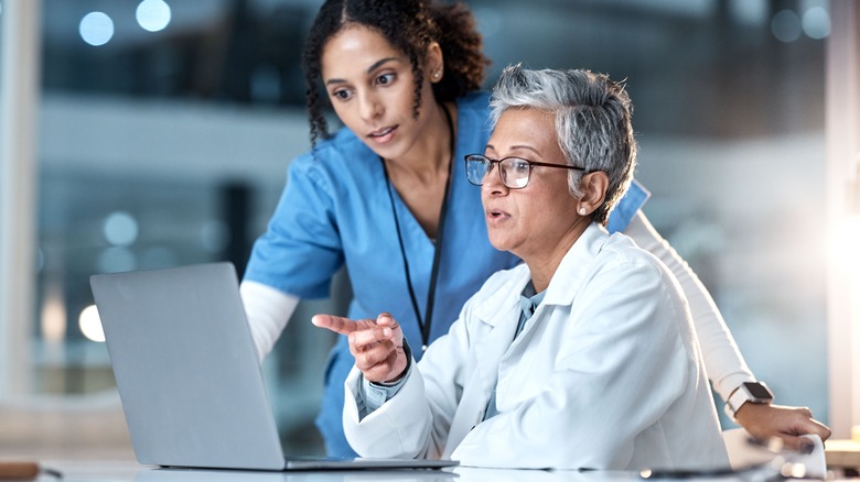 medical professionals looking at computer screen