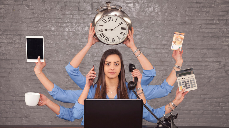 Multitasking businesswoman at desk in the office