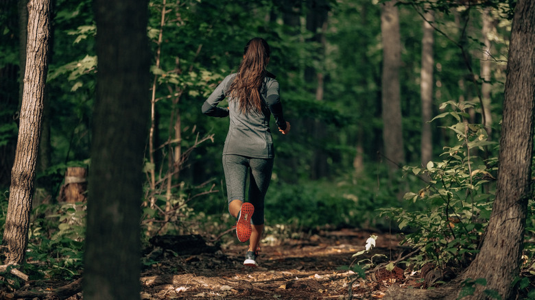 Woman jogging in woods