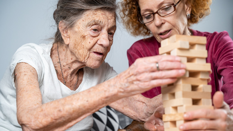 woman and elderly woman playing game