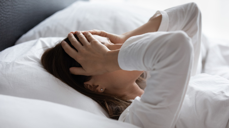 A woman lying bed after waking up tired