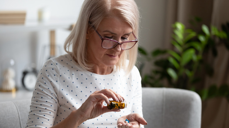 Older woman taking pills