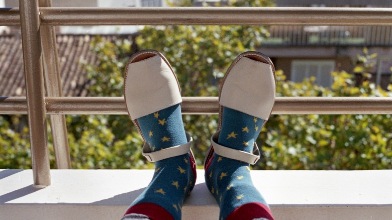 Person wearing socks with sandals