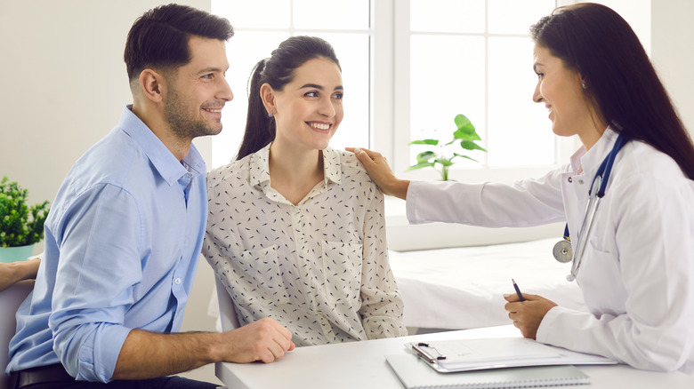 couple talking with fertility doctor