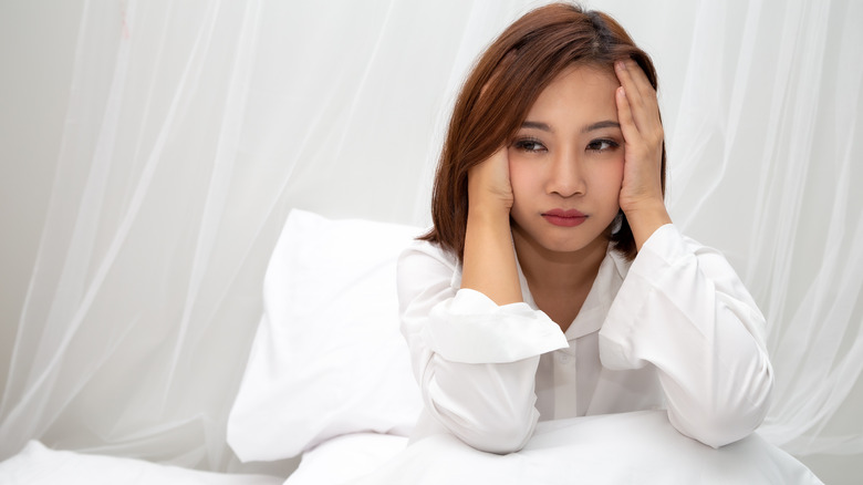 woman sitting in white bed