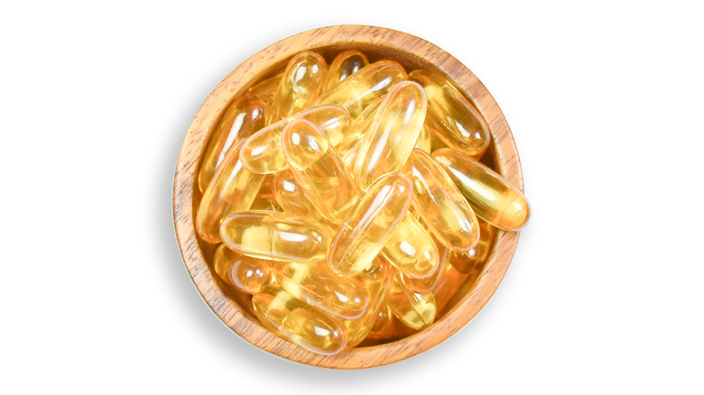 bowl of omega-3 capsules with a white background 