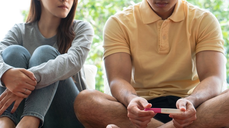 couple holding pregnancy test