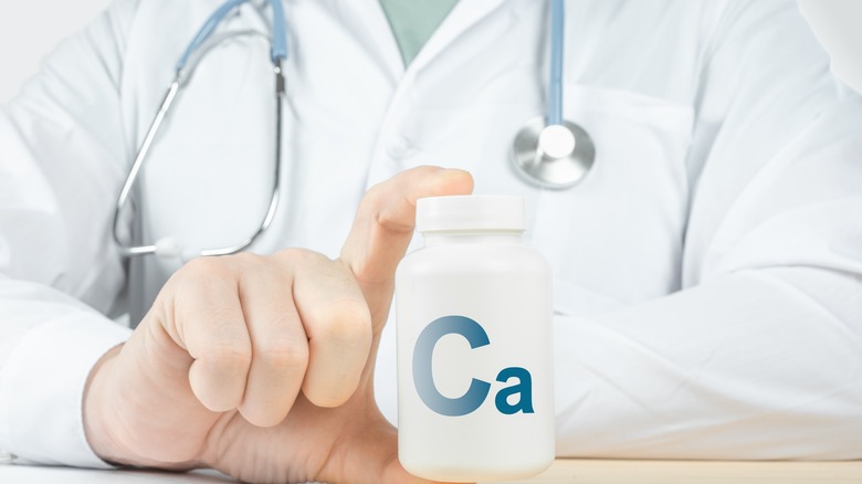 doctor holding calcium container