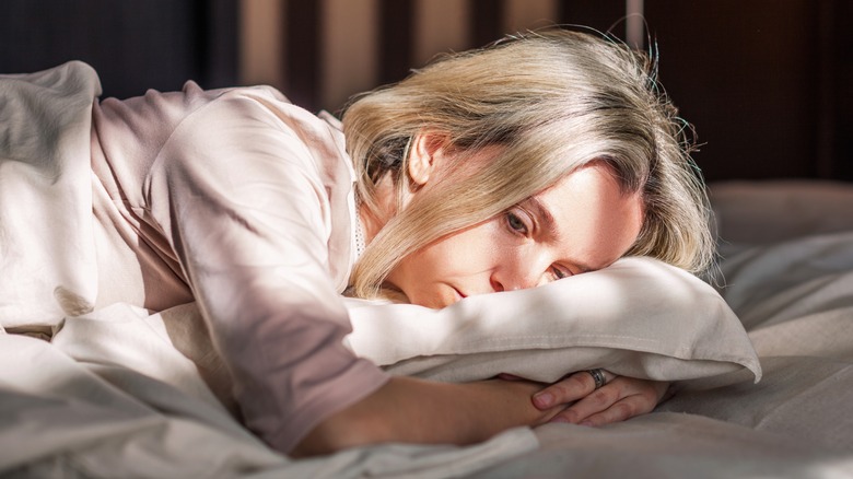 depressed woman in bed