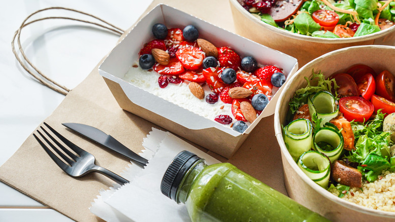 Bowls of salad and green smoothie