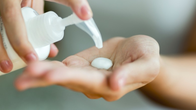 woman moisturizes hands