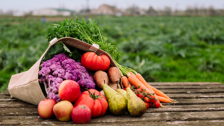 bag of fruits and vegetables on table outside