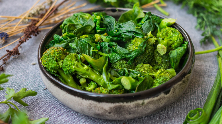 A large bowl of sautéed broccoli and spinach 
