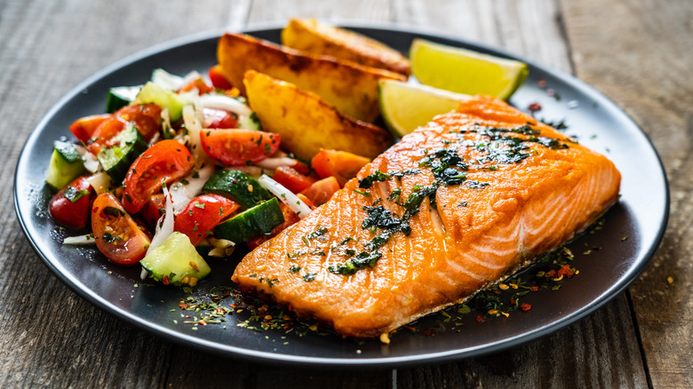 A plate with salmon and vegetables