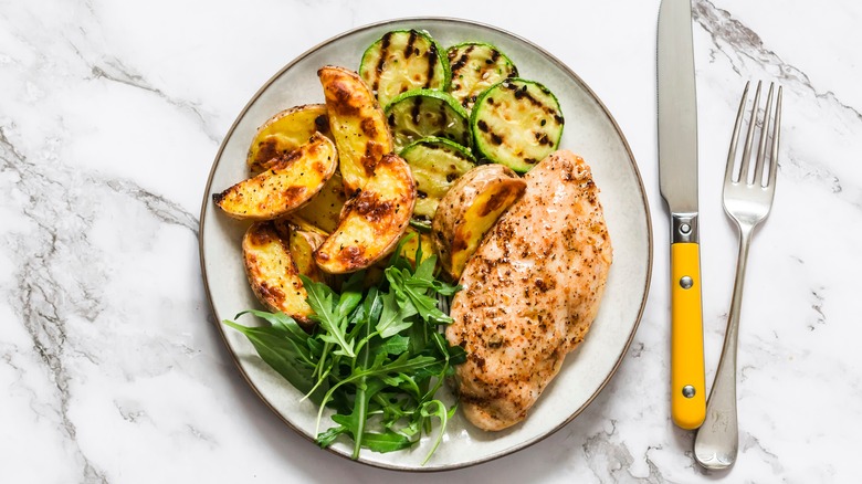 Plate of grilled chicken and vegetables