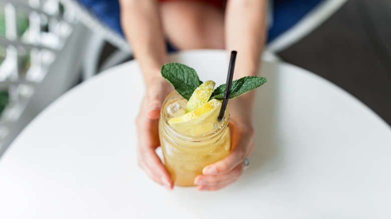 Woman holding glass of lemonade